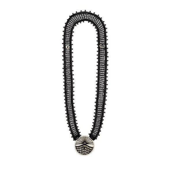 Black beaded necklace with a circular pendant on a white background