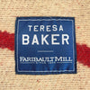 Teresa Baker Faribault Mill label on a textured fabric background