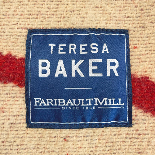 Teresa Baker Faribault Mill label on a textured fabric background