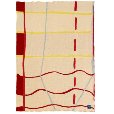 Beige blanket with red and yellow abstract patterns on a white background